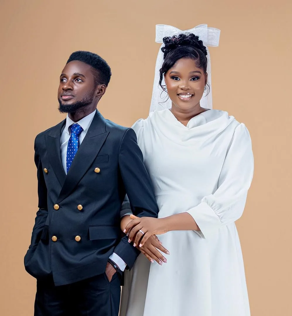 Precious and Michael dressed in white and navy for their portrait